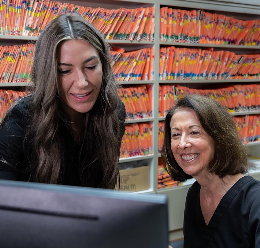Dental staff members look at a monitor inside the office of Andrew J. Sampalis, DDS and Associates, Ltd